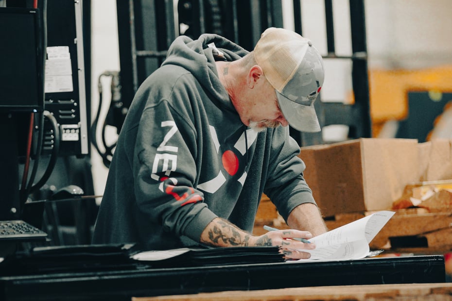 “NexGen Manufacturing quality technician inspecting incoming sheet metal materials for flatness, thickness, and certification at the Knightstown, Indiana facility.”