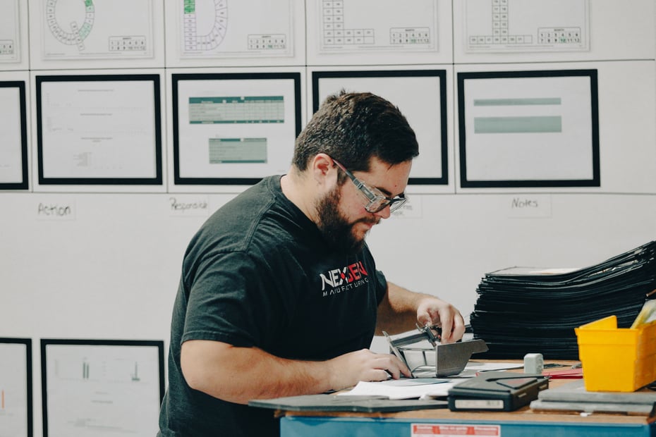 “Close-up of precision calipers measuring a machined metal part during quality inspection at NexGen Manufacturing’s metal fabrication facility.”