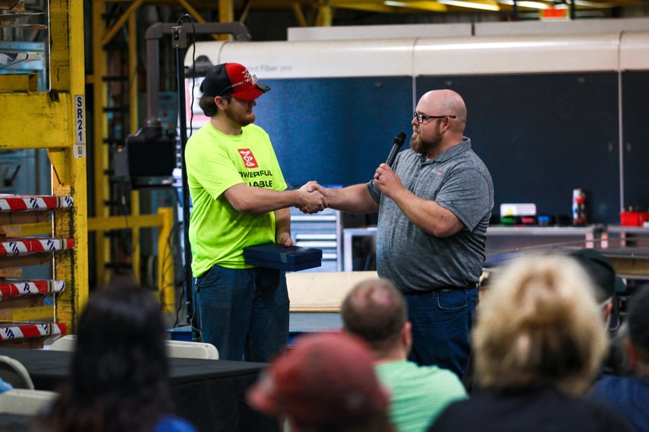 Daniel Webster presents the Core Value Award for Thoughtful Communication to Stephen Leathers at NexGen’s Q4 Townhall.